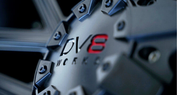 A close up of the DV8 logo on an alloy wheel.