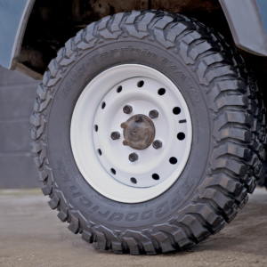 a land rover defender sat on white wolf steel wheels