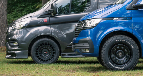 A Ford transit and a Volkswagen camper sat in field showing the difference between alloy wheels and Steel wheels UK, the alloy wheel is a DV8 works alloy wheel