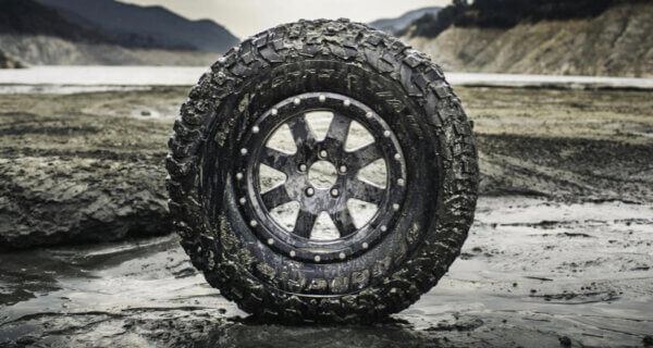 Mud Terrain tyre sat in a very muddy landscape