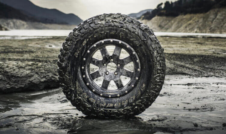 Mud Terrain tyre sat in a very muddy landscape