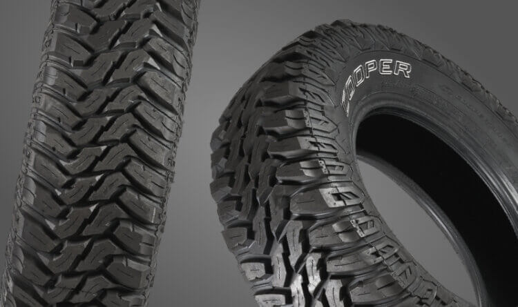 A cooper Discover mud terrain tyres shown on a grey background