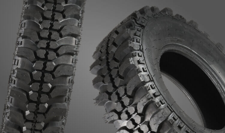 A mud terrain tyres show on a grey background