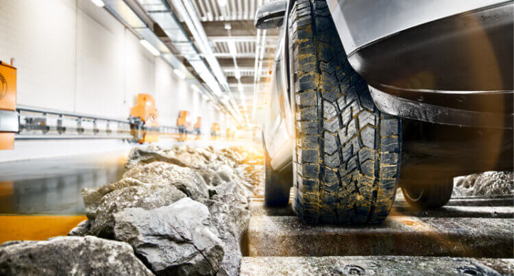 a tyre in a testing facility being tested on rough hard ground