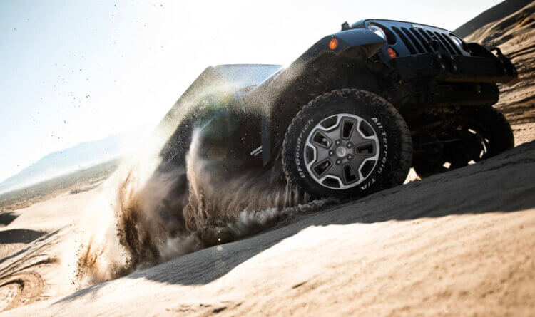 A jeep driving up a sandy hill on a BFGoodrich tyre showing off its Superior Traction