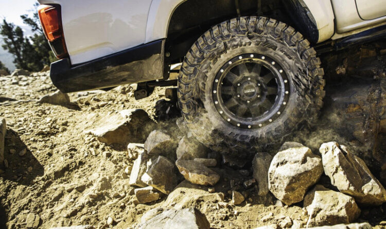 BFGoodrich Mud Terrain tyre - KM3 gripping a large rock as it climbs a hill