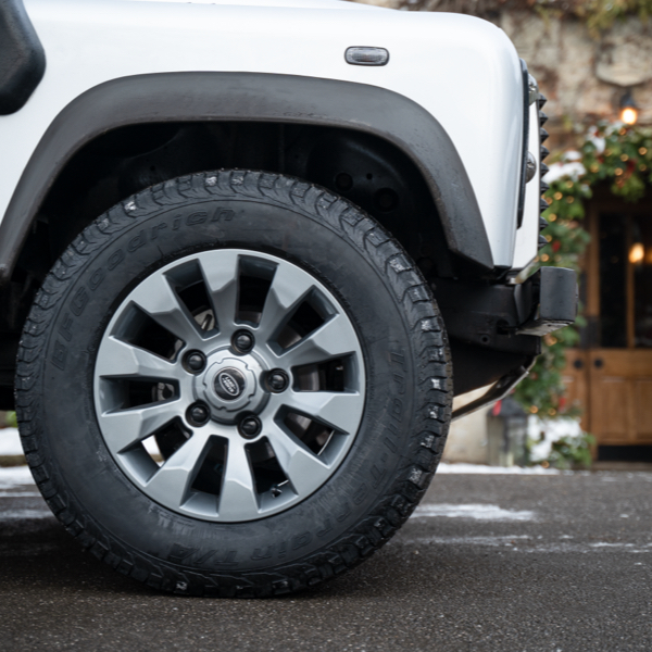 silver land rover sat on OEM sawtooth alloy wheels