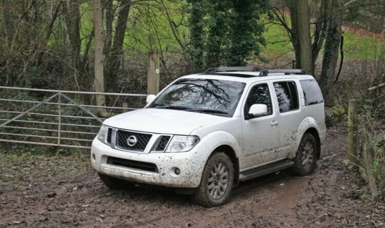 A Nissan Pathfinder green laning through thick mud in worcestershire.