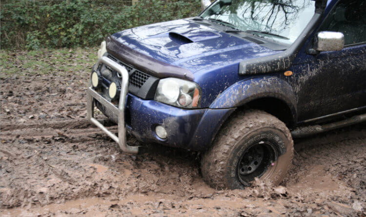 a 4x4 mud tyre moving through heavy mud for the A Beginner's Guide to Green Laning