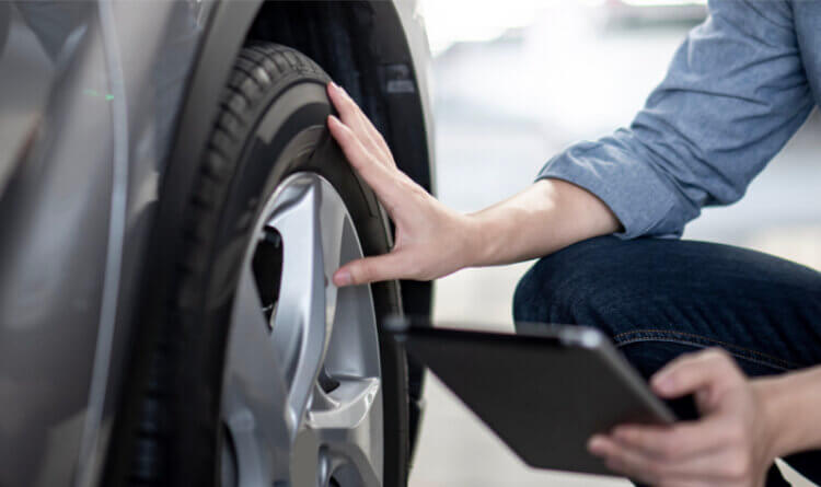 Best SUV tyres a person inspecting a tyre showing tyre knowledge