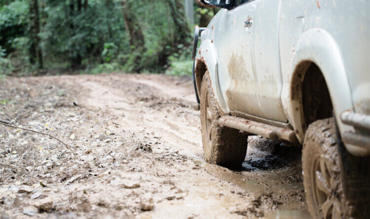 A 4x4 off-roading in heavy mud to illustrate Mud Terrain tyres Off roading