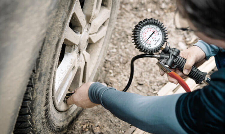 A driver prepping for Off-road driving by Adjusting Tyre Pressure