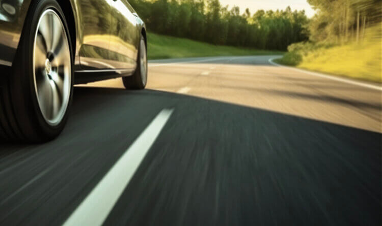 A SUV driving on a road in the summer to show Best SUV summer tyres