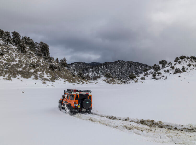 Land Rover Defender driving in snow