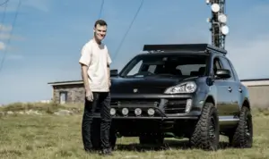 Overlanding Porsche Cayenne sat in a field