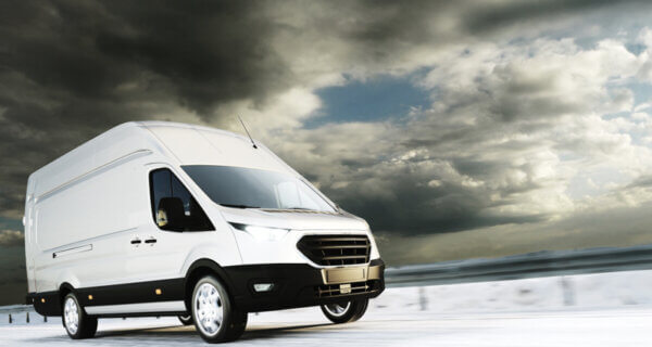 A white van driving through winter conditions sat on Van Winter Tyres