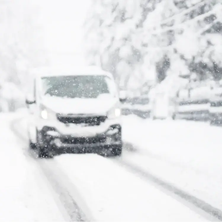A van driver driving in heavy snow sat Van Winter Tyres showing the Features of Quality Winter Van Tyres