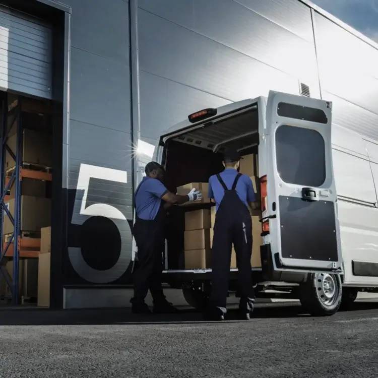 two commercial van drivers loading a delivery van to show its why Van tyres Understanding Van Tyres and load Ratings is important