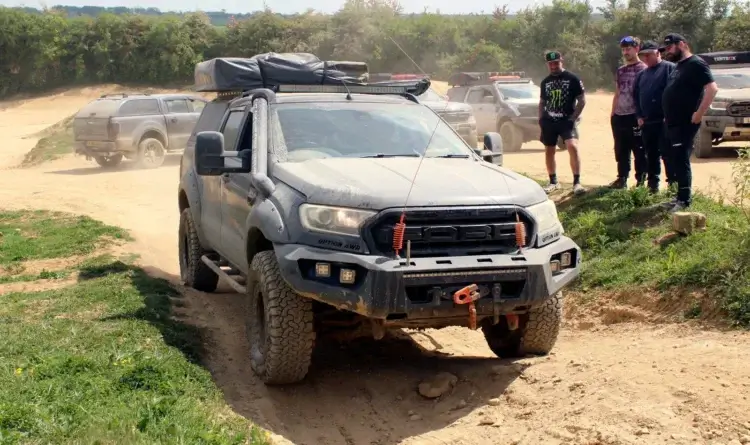 a group from the club checking out a modified ford ranger on a 4x4 track