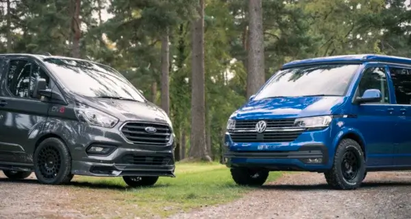 Commercial van and campervan facing each other, illustrating alloy versus steel wheels.