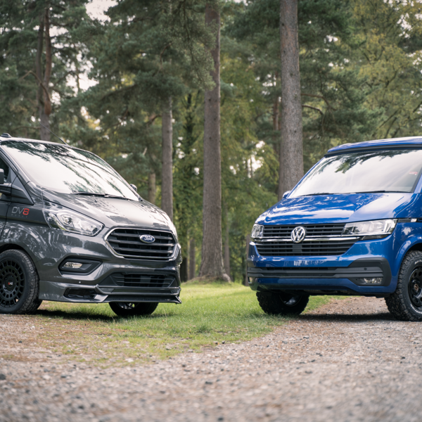 a commerical van and a camper van faceing each other to show Alloy Wheels vs Steel Wheels
