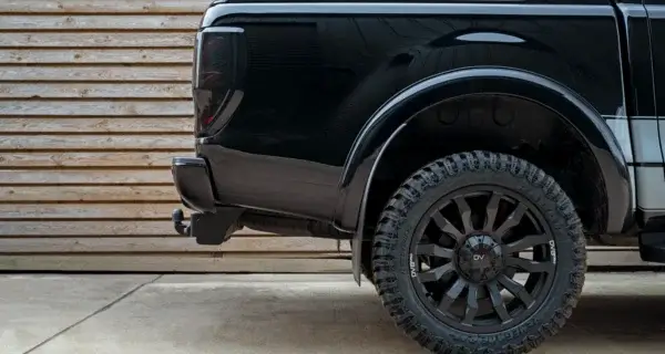 A ford ranger on alloy wheels and tyres in a yard