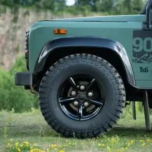 Close-up of Challenger 5 Spoke black alloy wheel fitted with Comforser CF3000 mud-terrain tyre on Land Rover Defender 90