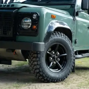 Front wheel detail showing Challenger 5 Spoke black alloy wheel and Comforser CF3000 mud-terrain tyre fitted to Land Rover Defender 90