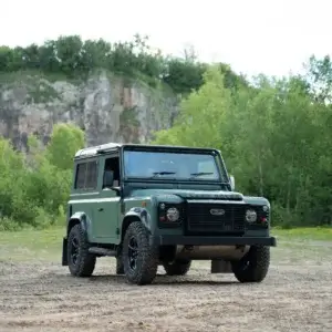 Front three-quarter view of Land Rover Defender 90 with Challenger 5 Spoke black alloy wheels and Comforser CF3000 mud-terrain tyres