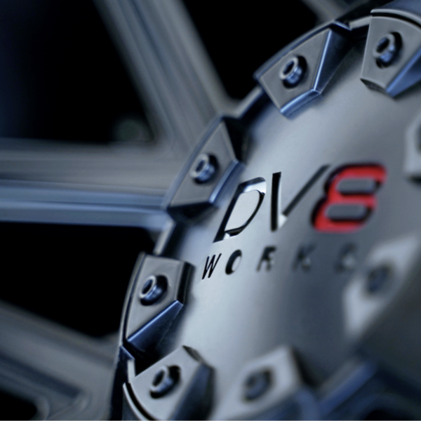 Close-up of DV8 Works alloy wheel centre cap and spoke detail