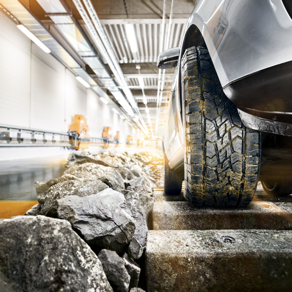 SUV tyre being tested over rocks and uneven surfaces for off-road durability