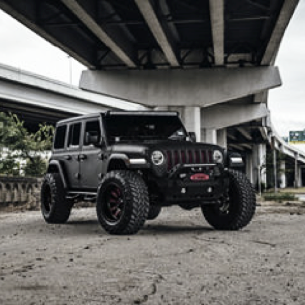 Black Jeep Wrangler fitted with Fuel off-road alloy wheels under a concrete overpass