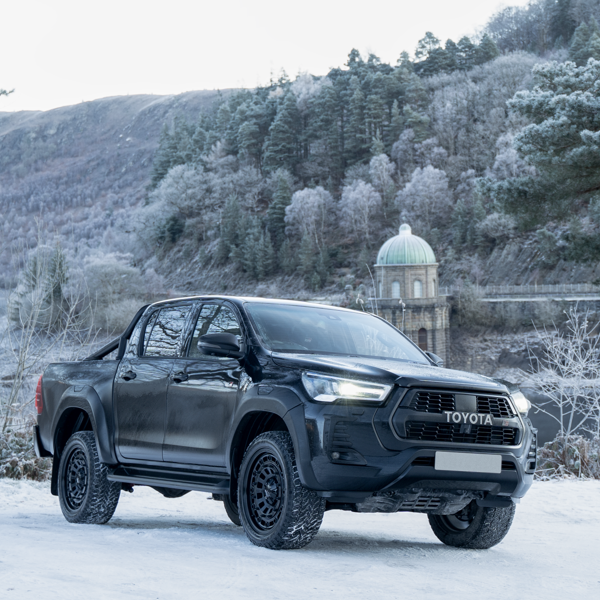 Toyota Hilux fitted with black DV8 Works alloy wheels in snow