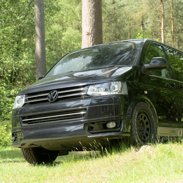 Volkswagen Transporter fitted with Comforser CF1100 all-terrain tyres on uneven woodland ground