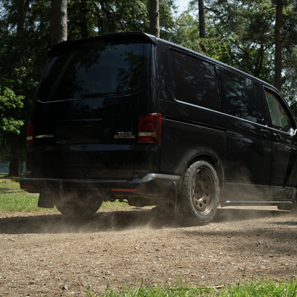 Volkswagen Transporter driving on a gravel track with Comforser CF1100 all-terrain tyres