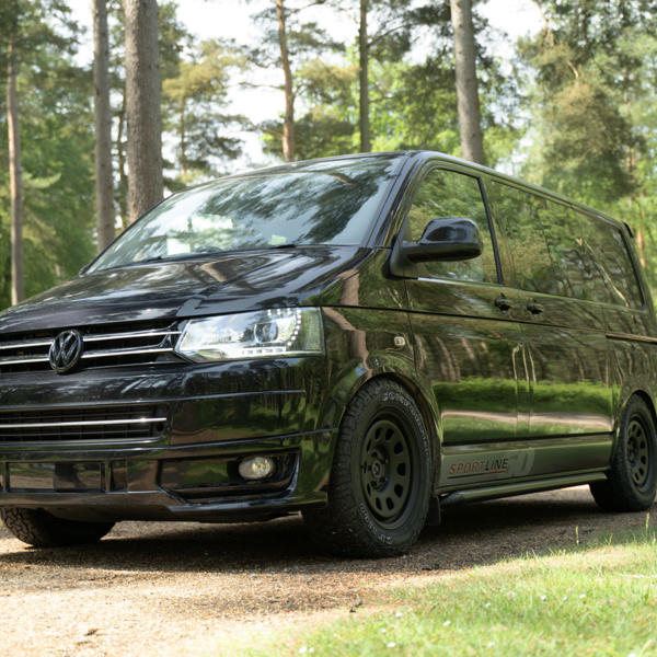 Volkswagen Transporter fitted with Comforser CF1100 all-terrain tyres on a woodland track