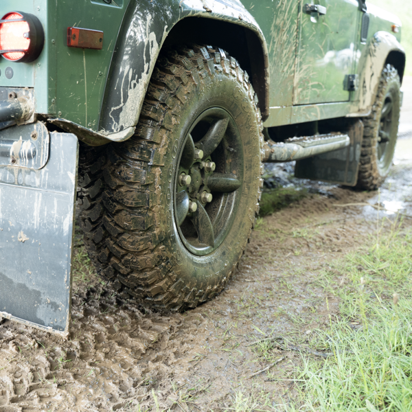 Comforser tyre fitted to a 4x4 driving through muddy off-road terrain