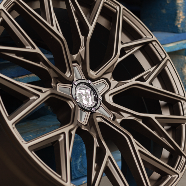 Close-up of bronze Wolfrace multi-spoke alloy wheels