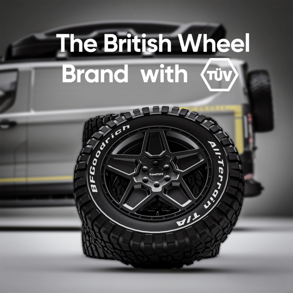 SuperMetal alloy wheel with all-terrain tyre beside a Land Rover Defender