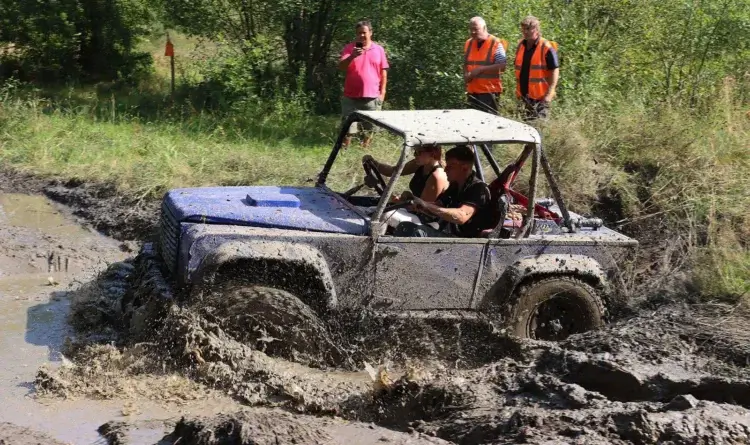 Team Broke’s blue trials car driving through deep mud on Insa Turbo tyres