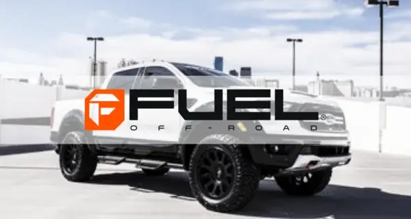 Fuel Off-Road logo over a white pickup truck with black alloy wheels and off-road tyres.