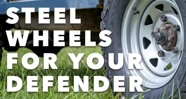 Close-up of a silver steel wheel on a Land Rover Defender, with the text “Steel Wheels for Your Defender”.